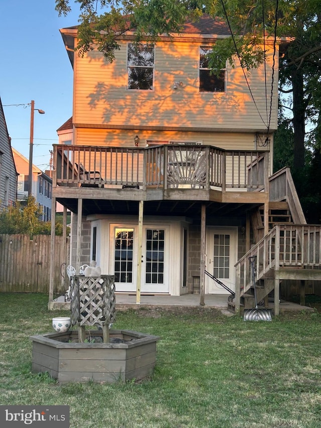 back of house with a deck, a patio area, and stairs