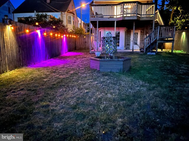 back of house featuring a wooden deck and stairway