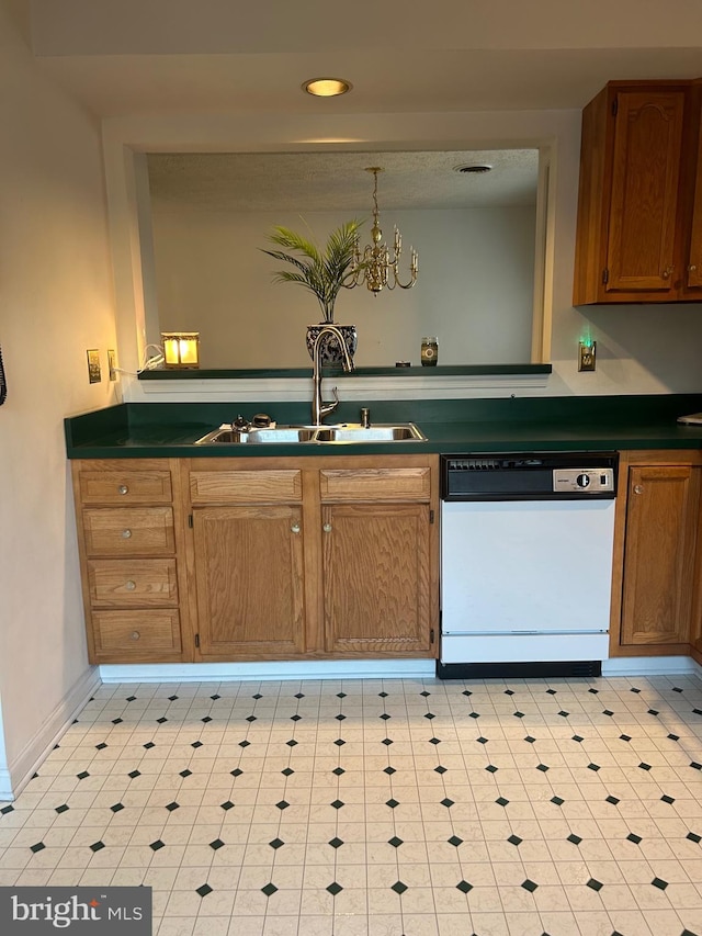 kitchen featuring dishwasher, a sink, dark countertops, light flooring, and recessed lighting