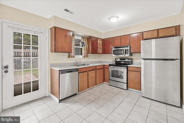 11132 Black Forest Way, Gaithersburg, MD 20879 - kitchen featuring stainless steel appliances, a sink, light countertops, and light tile patterned floors