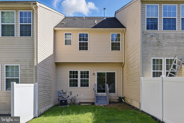 rear view of house featuring entry steps and central air condition unit