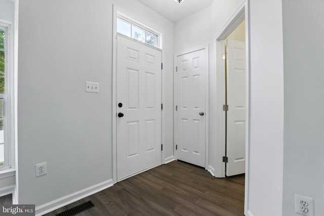 foyer entrance featuring dark wood-style floors and baseboards