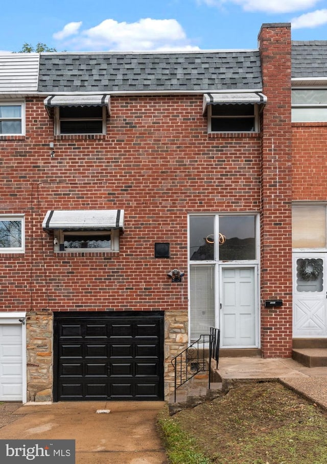 3583 Nottingham Ln, Philadelphia, PA 19114 - view of front of home featuring a garage, brick siding, mansard roof, and roof with shingles
