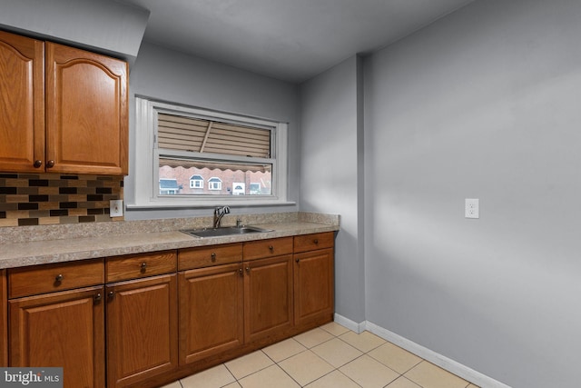3583 Nottingham Ln, Philadelphia, PA 19114 - kitchen featuring a sink, brown cabinets, baseboards, light tile patterned floors, and light countertops