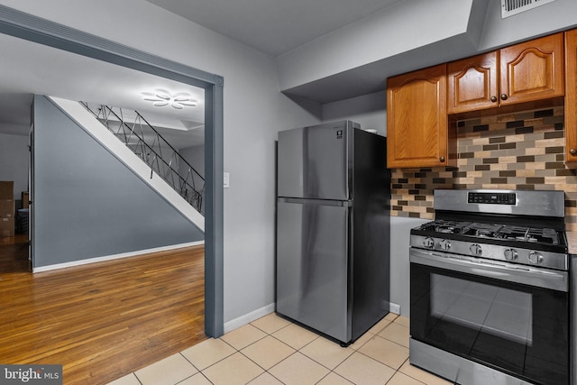 3583 Nottingham Ln, Philadelphia, PA 19114 - kitchen with appliances with stainless steel finishes, tasteful backsplash, baseboards, light wood-style floors, and brown cabinets