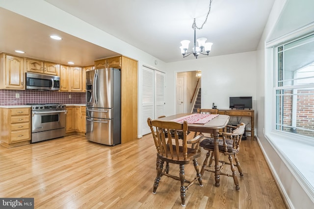 5 Kings House Ct, Silver Spring, MD 20905 - dining area featuring a chandelier, light wood finished floors, and stairs