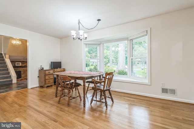 5 Kings House Ct, Silver Spring, MD 20905 - dining area with a chandelier, light wood-type flooring, and stairs