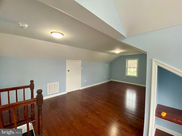 bonus room featuring vaulted ceiling, baseboards, and wood finished floors