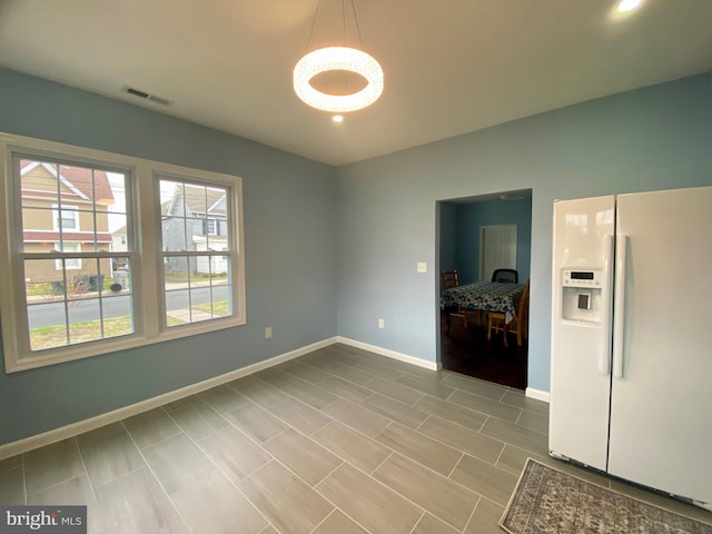 spare room with plenty of natural light, baseboards, a chandelier, and recessed lighting