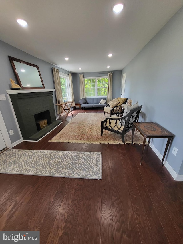1211 Williamsville Rd, Houston, DE 19954 - living area with wood finished floors, baseboards, recessed lighting, and a brick fireplace