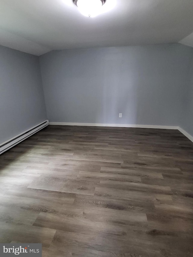 1211 Williamsville Rd, Houston, DE 19954 - empty room with vaulted ceiling, wood finished floors, baseboards, and a baseboard radiator