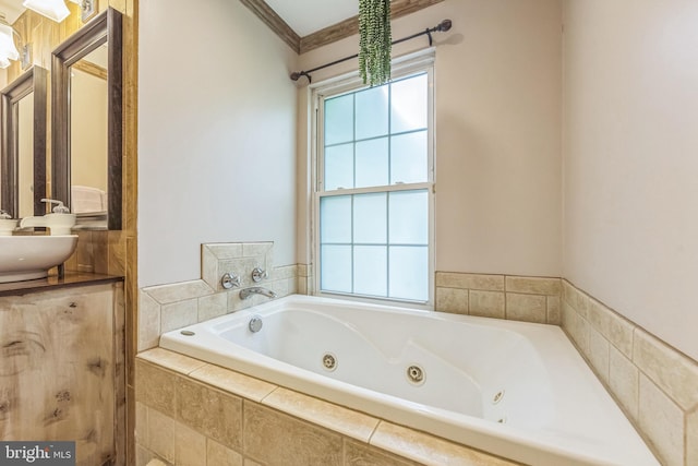 full bath featuring a whirlpool tub, ornamental molding, and vanity