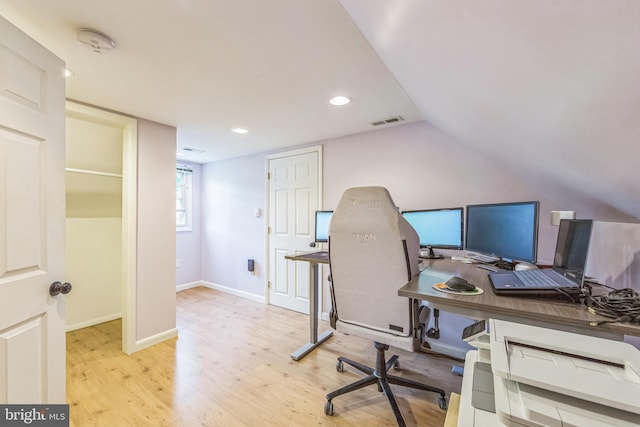 office space featuring wood finished floors, recessed lighting, lofted ceiling, and baseboards