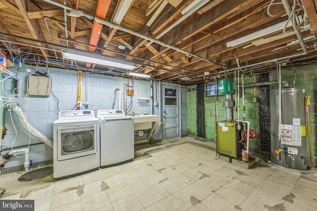 unfinished below grade area with gas water heater, independent washer and dryer, tile patterned floors, and a heating unit
