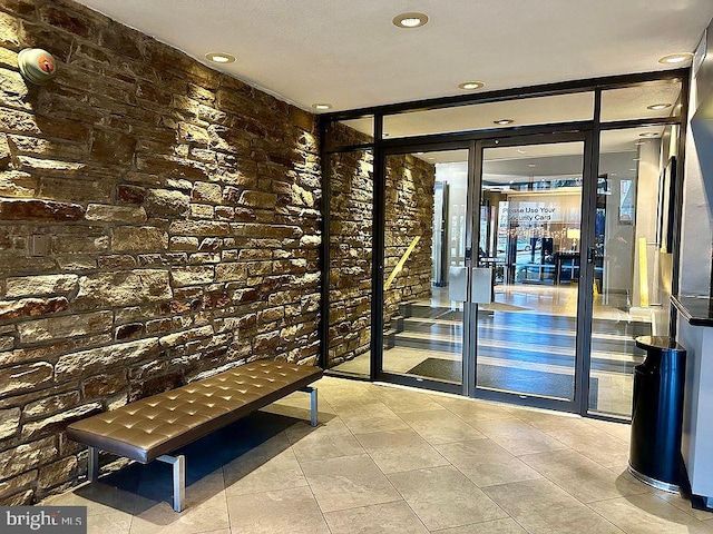 1 E University Pkwy Unit 1202, Baltimore, MD 21218 - wine room featuring a wall of windows, recessed lighting, tile patterned flooring, and brick wall