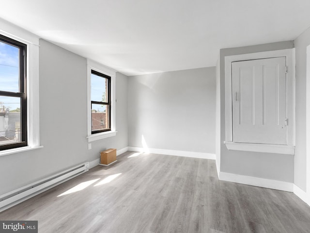 4951 W Thompson St, Philadelphia, PA 19131 - spare room with baseboard heating, wood finished floors, and baseboards