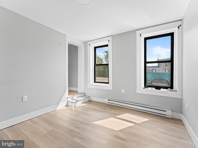 4951 W Thompson St, Philadelphia, PA 19131 - unfurnished room with a baseboard radiator, wood finished floors, and baseboards