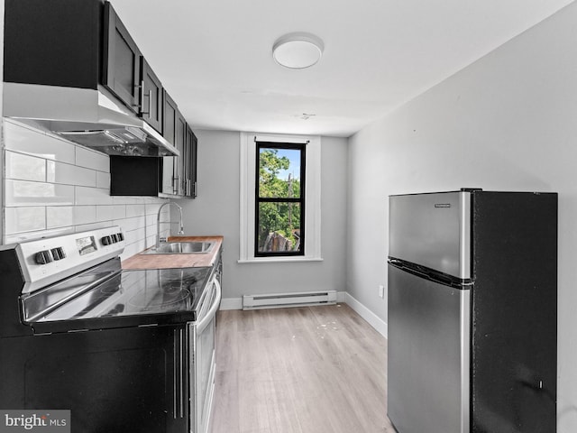 4951 W Thompson St, Philadelphia, PA 19131 - kitchen with stainless steel appliances, a baseboard heating unit, dark cabinets, a sink, and light wood-type flooring