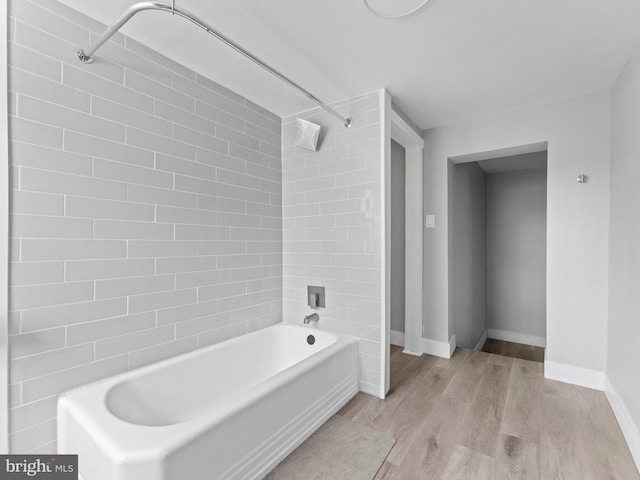 4951 W Thompson St, Philadelphia, PA 19131 - bathroom featuring wood finished floors, tub / shower combination, and baseboards