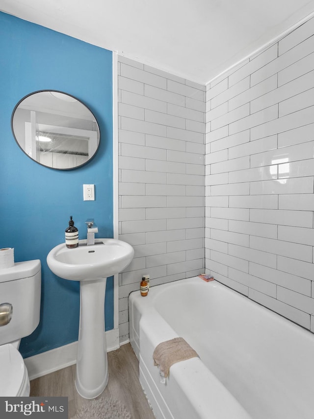 4951 W Thompson St, Philadelphia, PA 19131 - bathroom featuring wood finished floors, toilet, and baseboards