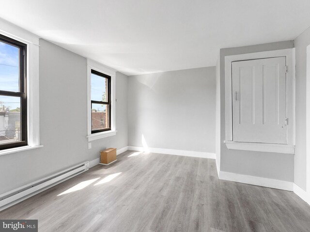 4951 W Thompson St, Philadelphia, PA 19131 - spare room with baseboard heating, wood finished floors, and baseboards