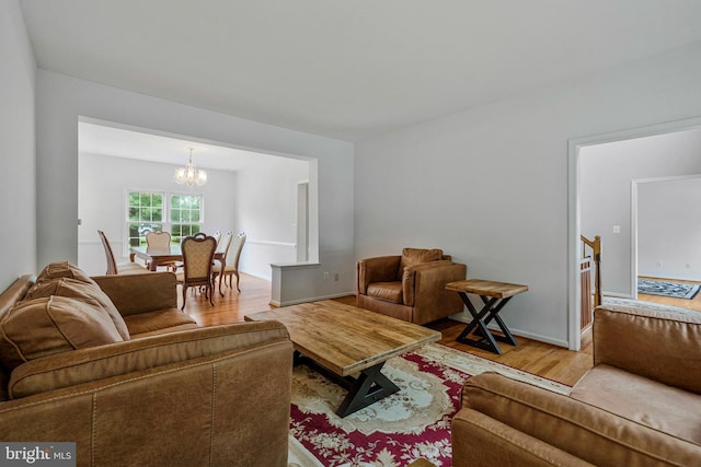 9310 Saffron Hill Ct, Manassas, VA 20110 - living room featuring wood finished floors, a chandelier, and baseboards
