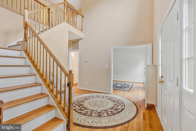 9310 Saffron Hill Ct, Manassas, VA 20110 - foyer featuring wood finished floors, stairs, a high ceiling, and baseboards