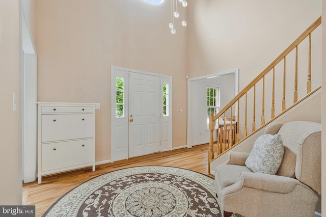 9310 Saffron Hill Ct, Manassas, VA 20110 - foyer entrance featuring wood finished floors, stairway, a high ceiling, and baseboards