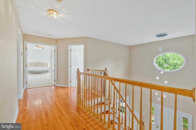9310 Saffron Hill Ct, Manassas, VA 20110 - hall with an upstairs landing, light wood-type flooring, and baseboards