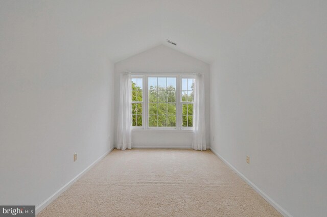 9310 Saffron Hill Ct, Manassas, VA 20110 - empty room with light carpet, vaulted ceiling, and baseboards
