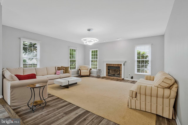 9310 Saffron Hill Ct, Manassas, VA 20110 - living area with dark wood finished floors, healthy amount of natural light, and a brick fireplace