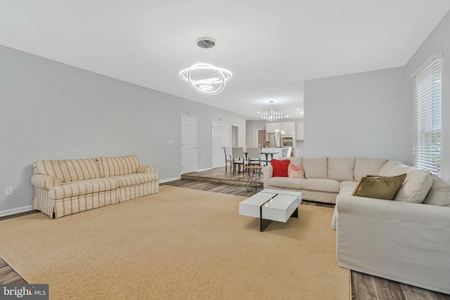 9310 Saffron Hill Ct, Manassas, VA 20110 - living room featuring a chandelier, baseboards, and wood finished floors