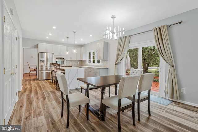 9310 Saffron Hill Ct, Manassas, VA 20110 - dining area featuring light wood-style floors, a chandelier, baseboards, and recessed lighting