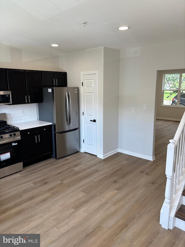 1853TOBIASDRIVESE Tobias Dr SE, Washington, DC 20020 - kitchen with appliances with stainless steel finishes, dark cabinetry, light wood finished floors, and recessed lighting