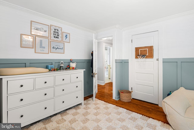 328 Avondale Ave, Haddonfield, NJ 08033 - bedroom featuring ornamental molding, wainscoting, light wood-type flooring, and a decorative wall