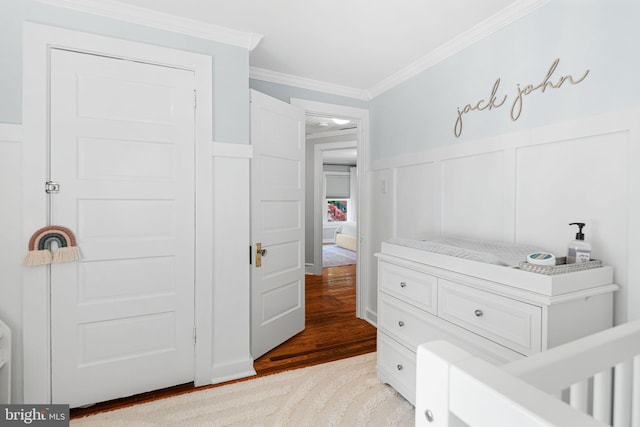 328 Avondale Ave, Haddonfield, NJ 08033 - bedroom with a decorative wall, ornamental molding, light wood-style flooring, and wainscoting