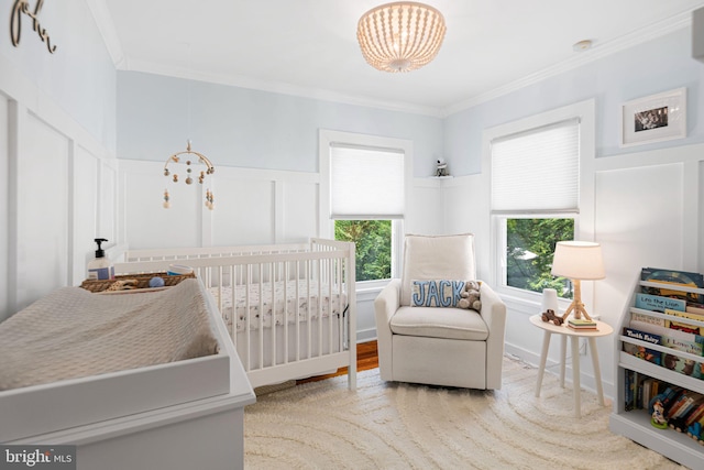 328 Avondale Ave, Haddonfield, NJ 08033 - bedroom with multiple windows, a decorative wall, a crib, a chandelier, and ornamental molding