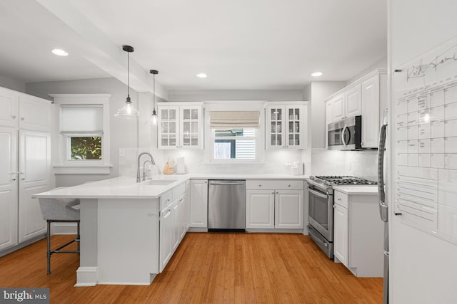 328 Avondale Ave, Haddonfield, NJ 08033 - kitchen featuring appliances with stainless steel finishes, a sink, a peninsula, healthy amount of natural light, and recessed lighting