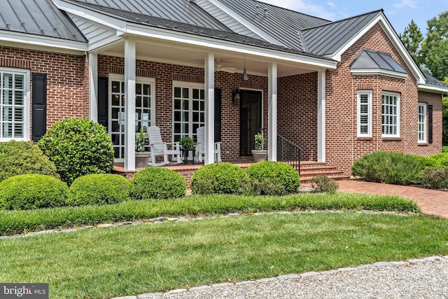 125 Oyster Pt, White Stone, VA 22578 - entrance to property with a standing seam roof, brick siding, metal roof, and a yard
