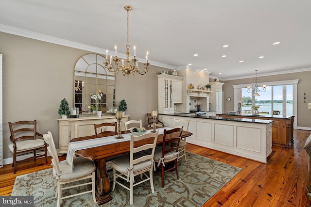125 Oyster Pt, White Stone, VA 22578 - dining area with a chandelier, light wood-style flooring, ornamental molding, recessed lighting, and baseboards