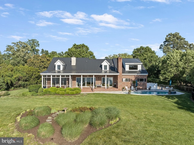 125 Oyster Pt, White Stone, VA 22578 - rear view of house with brick siding, a chimney, a sunroom, a standing seam roof, and metal roof