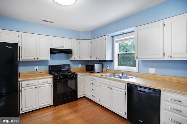 kitchen featuring black appliances, under cabinet range hood, a sink, and light countertops