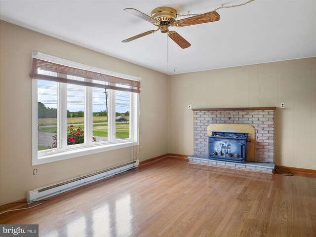 13914 Greencastle Pike, Hagerstown, MD 21740 - unfurnished living room featuring a baseboard radiator, a ceiling fan, wood finished floors, baseboards, and a fireplace