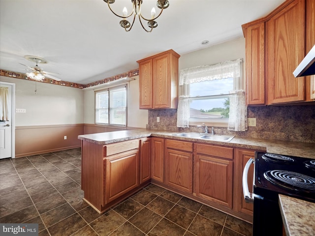 13914 Greencastle Pike, Hagerstown, MD 21740 - kitchen with a sink, a peninsula, backsplash, a ceiling fan, and black range with electric cooktop