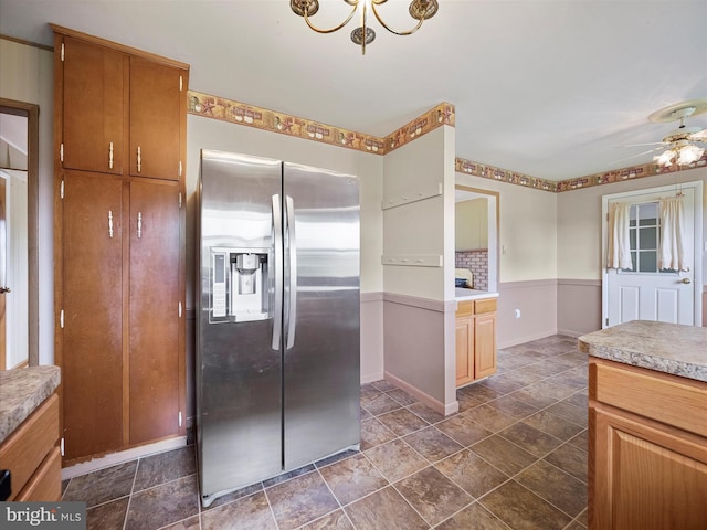 13914 Greencastle Pike, Hagerstown, MD 21740 - kitchen featuring stainless steel refrigerator with ice dispenser, light countertops, a chandelier, stone finish flooring, and baseboards