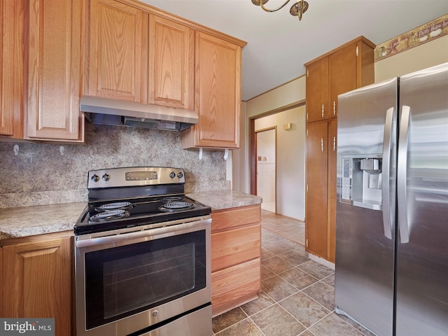 13914 Greencastle Pike, Hagerstown, MD 21740 - kitchen featuring stainless steel appliances, under cabinet range hood, light countertops, backsplash, and light tile patterned floors