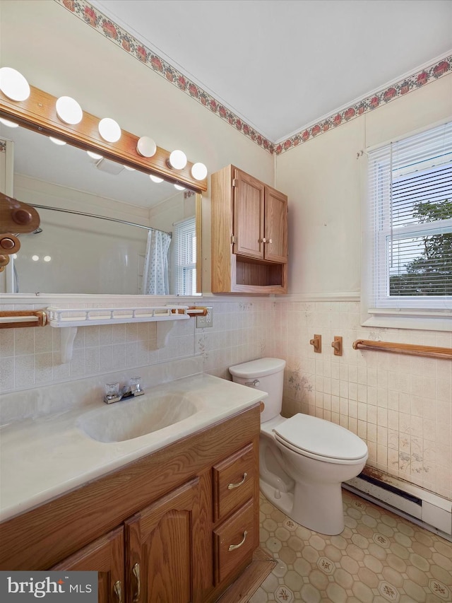 13914 Greencastle Pike, Hagerstown, MD 21740 - bathroom featuring tile walls, baseboard heating, vanity, toilet, and a wainscoted wall