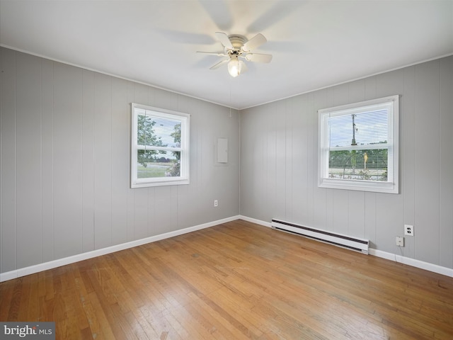 13914 Greencastle Pike, Hagerstown, MD 21740 - unfurnished room featuring a baseboard radiator, plenty of natural light, a ceiling fan, and hardwood / wood-style floors