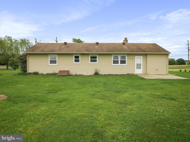 13914 Greencastle Pike, Hagerstown, MD 21740 - rear view of house with a patio, a yard, a chimney, and roof with shingles
