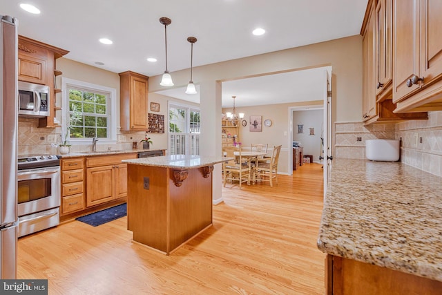 5617 Rowena Dr, Centreville, VA 20120 - kitchen with appliances with stainless steel finishes, a sink, light wood-type flooring, decorative backsplash, and recessed lighting